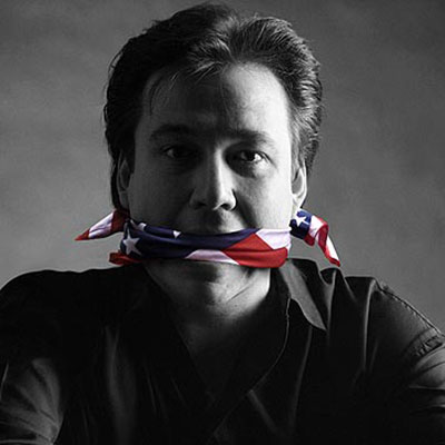 The late US comedian Bill Hicks pictured gagged with a US flag. 